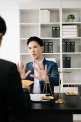Lawyer refusing bribe money in the envelop from businessman at the lawyer office.