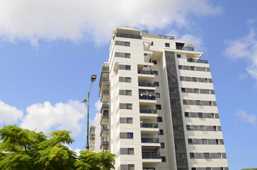 Modern residential area. Flowering trees near the new building. Luxury real estate. Investment in...