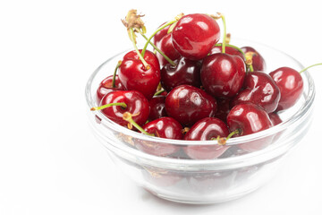 Cherries in the bowl isolated above white background with copy space