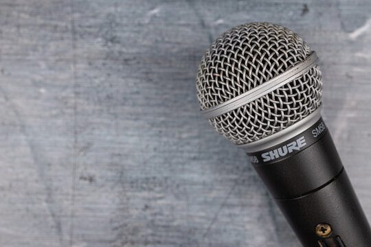 Belgrade, Serbia - 09. June 2023. - Shure SM58 microphone closeup above blue background