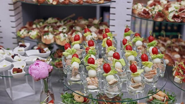 Buffet and snacks at a business event. Catering serves a banquet, beautiful and neat snacks are laid out on trays for guests.