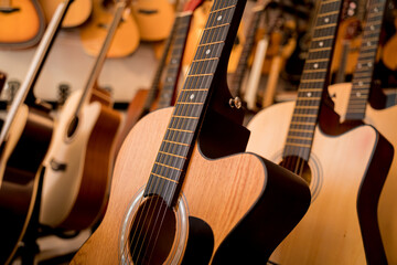 Fototapeta na wymiar Many rows of classical guitars in the music shop
