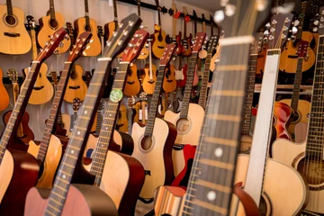 Garden poster Music store Many rows of classical guitars in the music shop