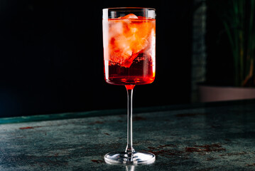Aperol spritz cocktail in a glass with ice and orange