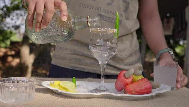 Drinks and people concept. Young man preparing cashew juice cocktail.