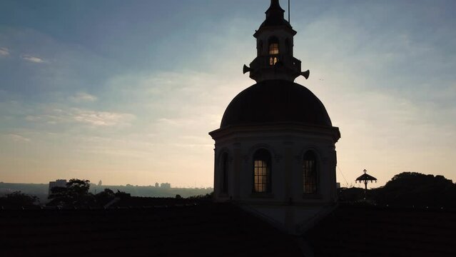 Church, beautiful images of the steeple of a church against the light of dawn in a small town in Brazil, 4k, drone scene.