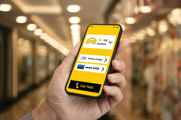 Man hand holding phone with taxi call application on screen