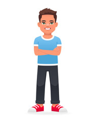 A cheerful little boy stands with his arms crossed. A beautiful cute white schoolboy kid in a blue T-shirt.