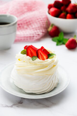 Meringues Pavlova cake with fresh straberry and mascarpone cream. Recipe of traditional dessert Anna Pavlova. Homemade bakery.