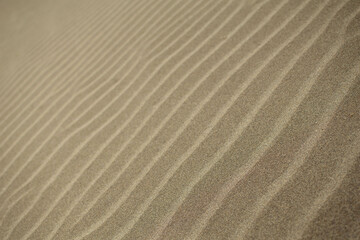 Fototapeta na wymiar abstract image of line patterns in the sand along a Spanish beach desktop background wallpaper