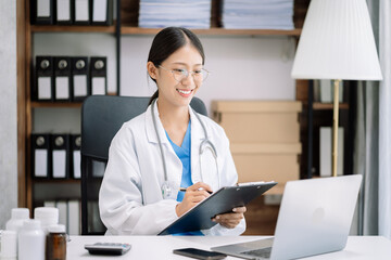 Female medicine doctor hand holding silver pen writing something on clipboard close up. Ward round, patient visit check, medical calculation and statistics concept.