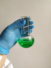 hand holding tube with liquid