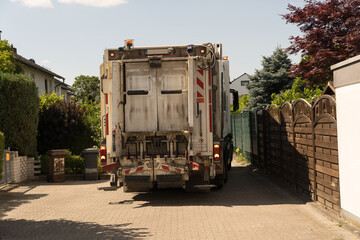 Mörfelden-Walldorf, GERMANY, June 14, 2023 : A garbage truck reverses into a small street in Germany to pick up garbage