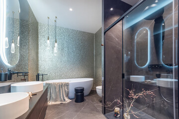 Exquisite bathroom design. Modern shower cabin, stylish accessories. Oval mirrors with...