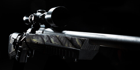 Riflescope on a bolt action rifle with a black background
