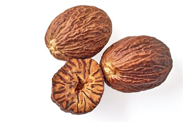 three nutmegs on a white background. top view