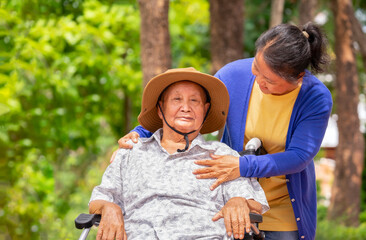 old disability grandfather sit on wheelchair,a daughter take care,support,having conversation with...