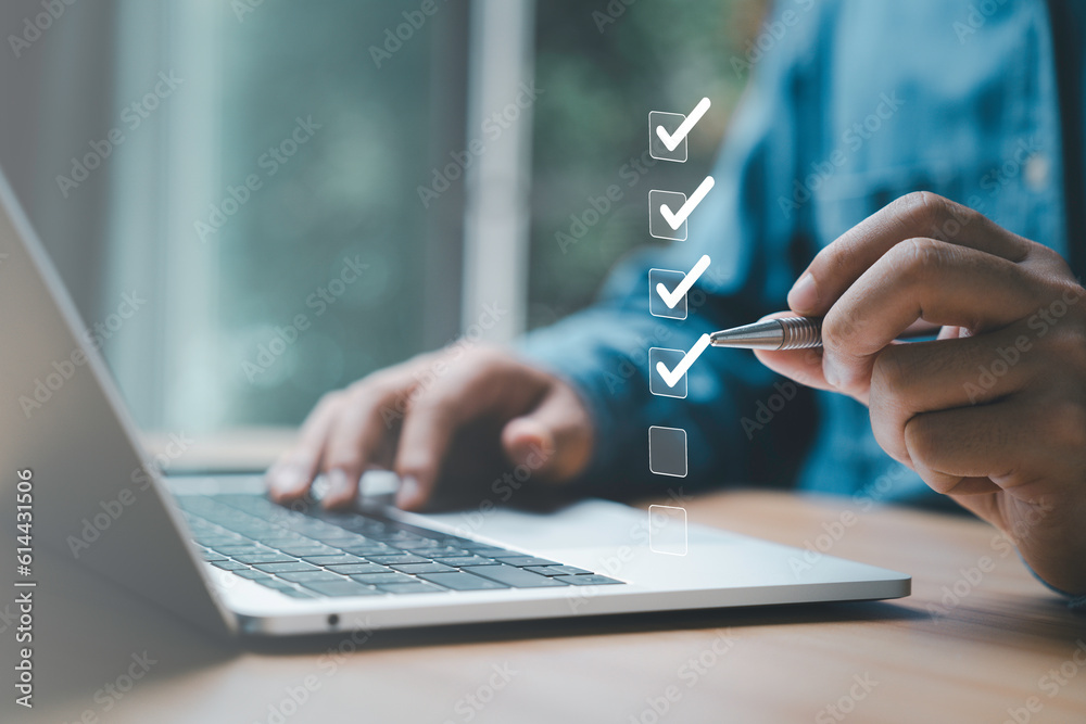 Aufkleber Businessman use pen to tick correct sign mark in checkbox for quality document control checklist and business approve project concept.