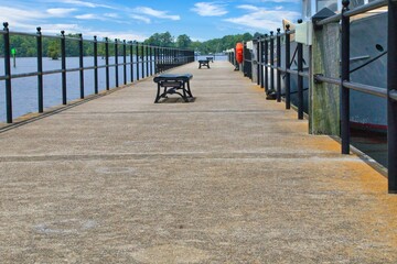 The photo captures the essence of Edenton waterfront charm—a tranquil pier extending into the sparkling bay, inviting you to stroll along its wooden planks and immerse yourself in the natural beauty