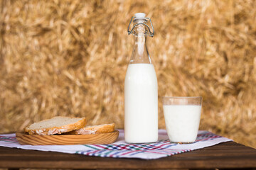 Rustic breakfast of milk, fresh wheat bread and butter in the haylof