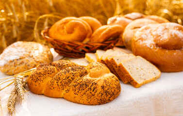 lot of different flavored bread, wheat, rye, on the table in the field outside