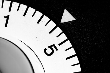 monochrome close-up of an old analog laboratory timer set to four
