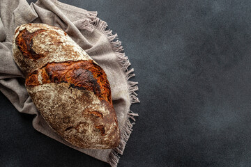Fresh homemade sourdough bread on a dark background. banner, menu, recipe place for text, top view