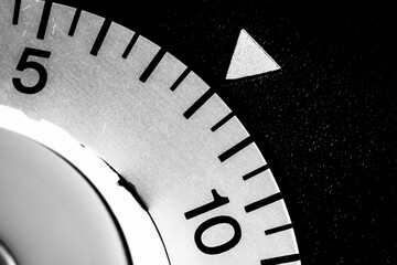 monochrome close-up of an old analog laboratory timer set to eight