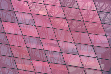 Pink texture from the glass of a modern building. Tech office background.