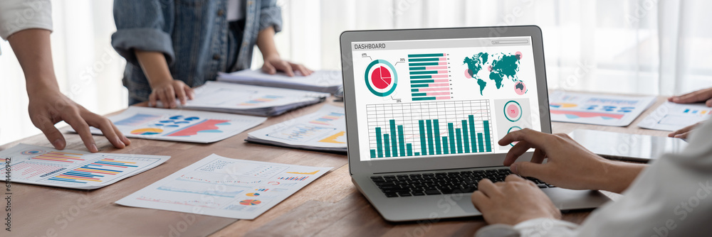 Fototapete Panorama shot analyst team utilizing BI Fintech to analyze financial report with laptop. Businesspeople analyzing BI power dashboard displayed on laptop screen for business insight. Scrutinize