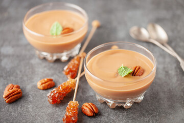 Homemade butterscotch pudding in glass cream bowl on the table. National Butterscotch Pudding Day