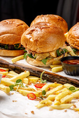 Burgers on wood board with french fries