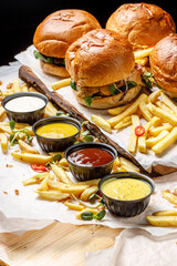 Burgers on wood board with french fries