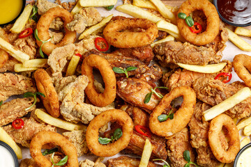Fried chicken and onion rings with sauce