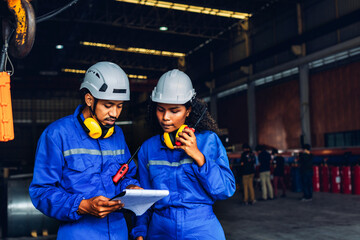 Fototapeta premium Workers Factory or Engineering work at factory site check up machine or products in site. Foreman or Technician checking Material or Machine on Plant. Heavy industry factory concept.