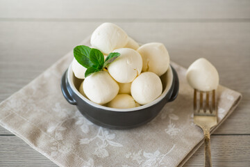 Small balls of traditional mozzarella in a ceramic bowl