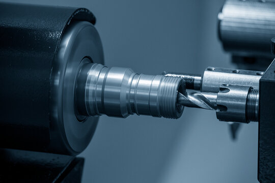 The  CNC lathe machine boring  cutting the brass material parts by drill tool.