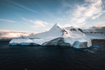 Beautiful snow-capped mountains against the sunset sky in Antarctica. Global warming and travel...