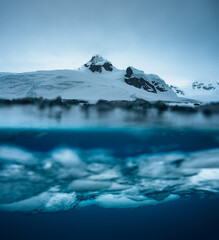 Split view of an iceberg showing above and below the water line, Antarctica. Arctic Greenland....