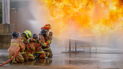 close-up photo of a firefighter Firefighters train firefighters using water and fire extinguishers to fight flames in emergency situations. in dangerous situations.
