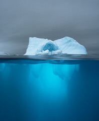 Split view of an iceberg showing above and below the water line. Underwater iceberg. Antarctica....