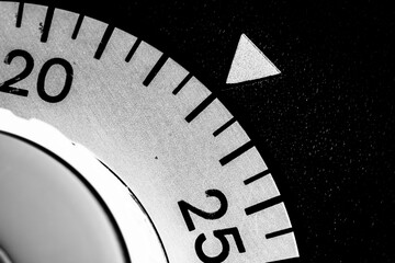 monochrome close-up of an old analog laboratory timer set to 23