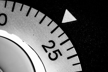 monochrome close-up of an old analog laboratory timer set to 24