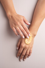 An orange smudge of scrub on a hand