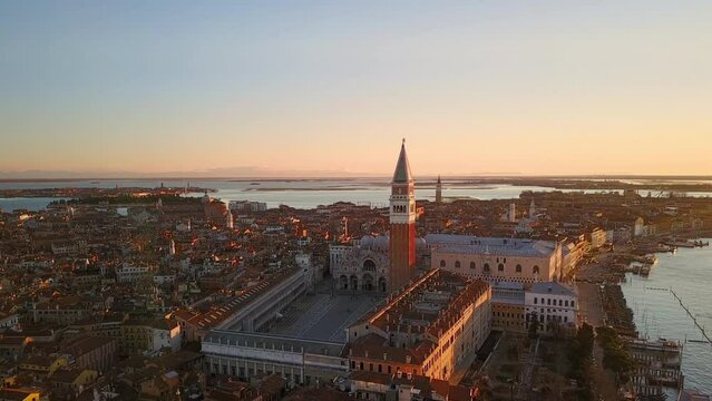 aerial view of venice city centre seen through a window,drone moving out from inside the room flying over old town san marco square at sunrise