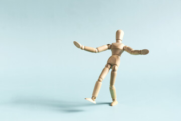 The wooden man takes a step forward in close-up.