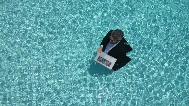 Excited business man in wet suit in sea or pool. Funny businessman, crazy comic business concept. Remote online working. Crazy hot summer business. Fun business lifestyle. Funny amazed businessman.