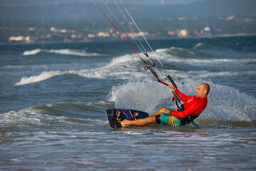 Kitesurfing on the waves of the sea in Mui Ne beach, Phan Thiet, Binh Thuan, Vietnam. Kitesurfing,...