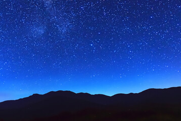 Colorful night sky landscape with starry sky. Mountain blue night sky with bright stars