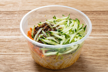 angle view traditional Beijing noodles with soy bean paste in a takeaway bowl